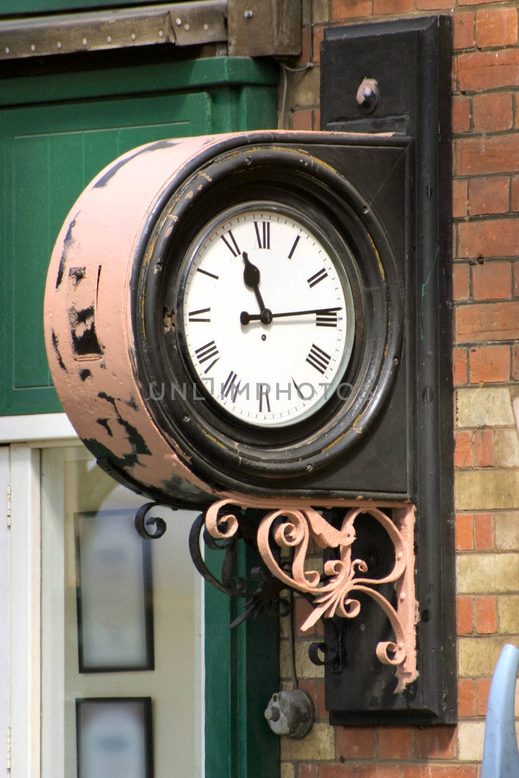 old clock in use at a railway station
