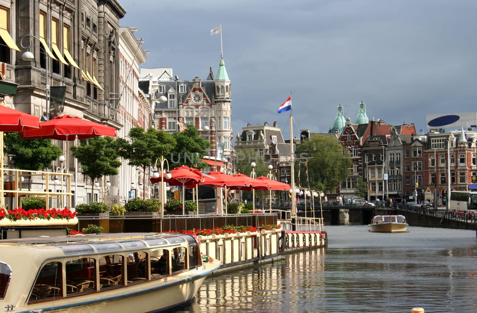 Tour boats in a canal outside a restaurant in Amsterdam
