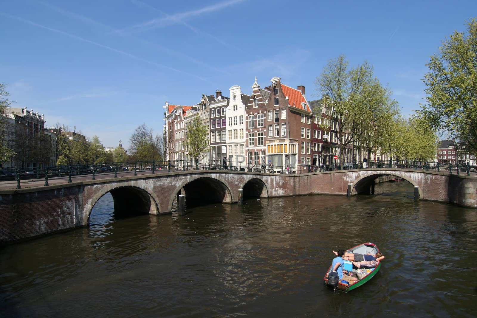 Man and woman boating in an Amsterdam canal