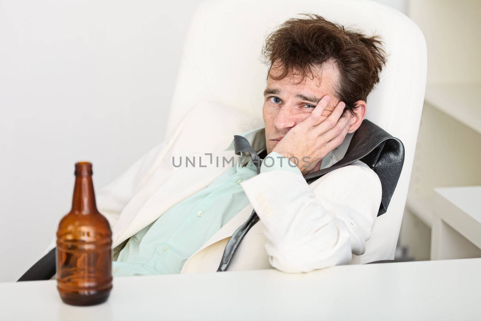 The guy is suffering from a hangover because beer is gone