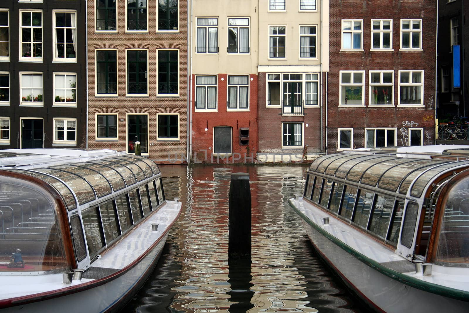 Tourboats in a canal in Amsterdam
