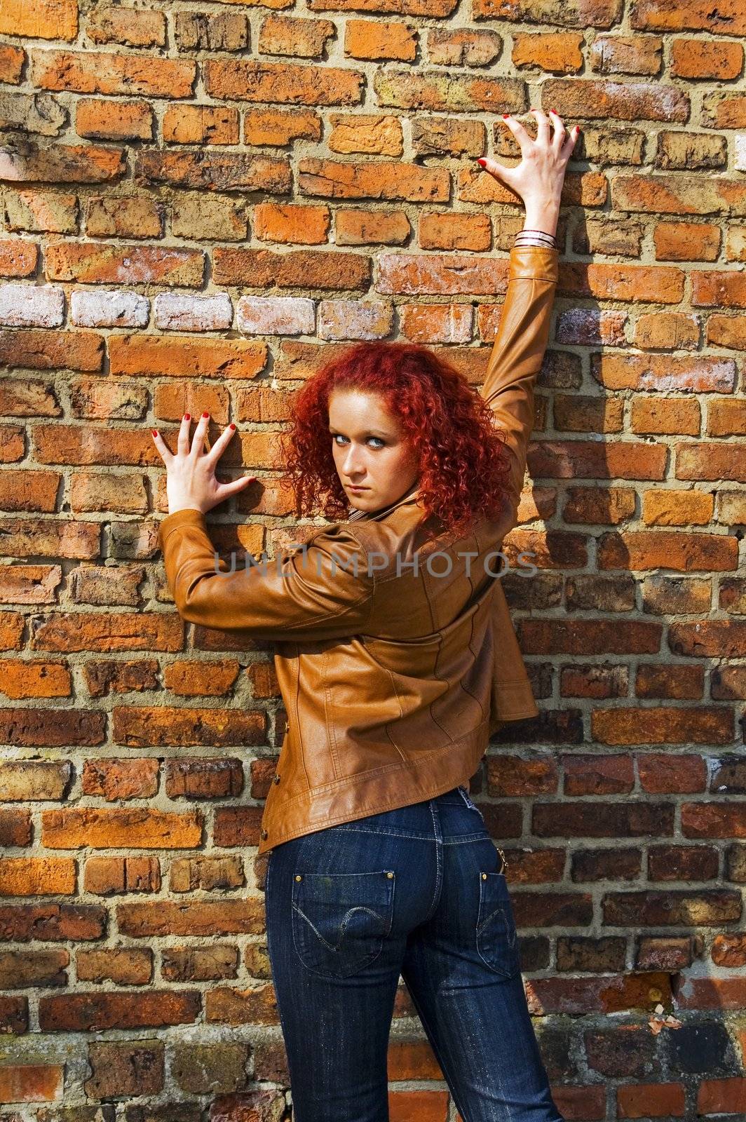 Beautiful young women over bricked wall