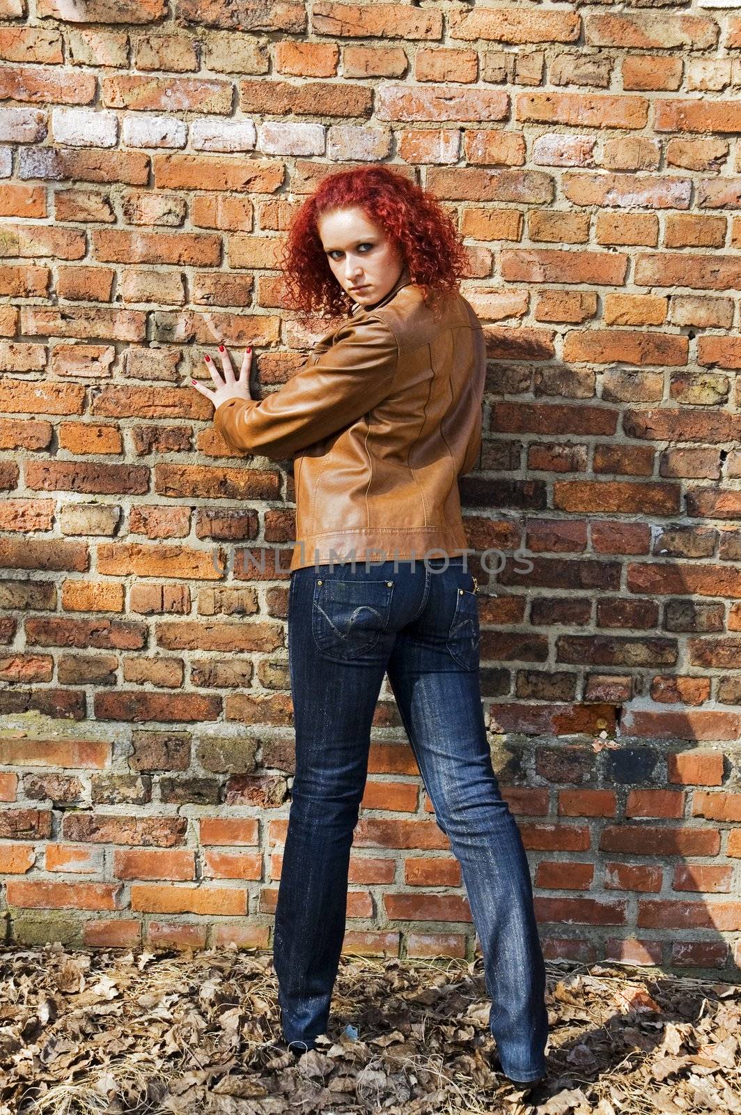 Beautiful young women over bricked wall