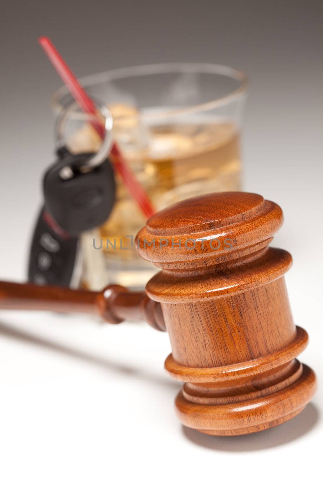 Gavel, Alcoholic Drink & Car Keys on a Gradated Background - Drinking and Driving Concept.