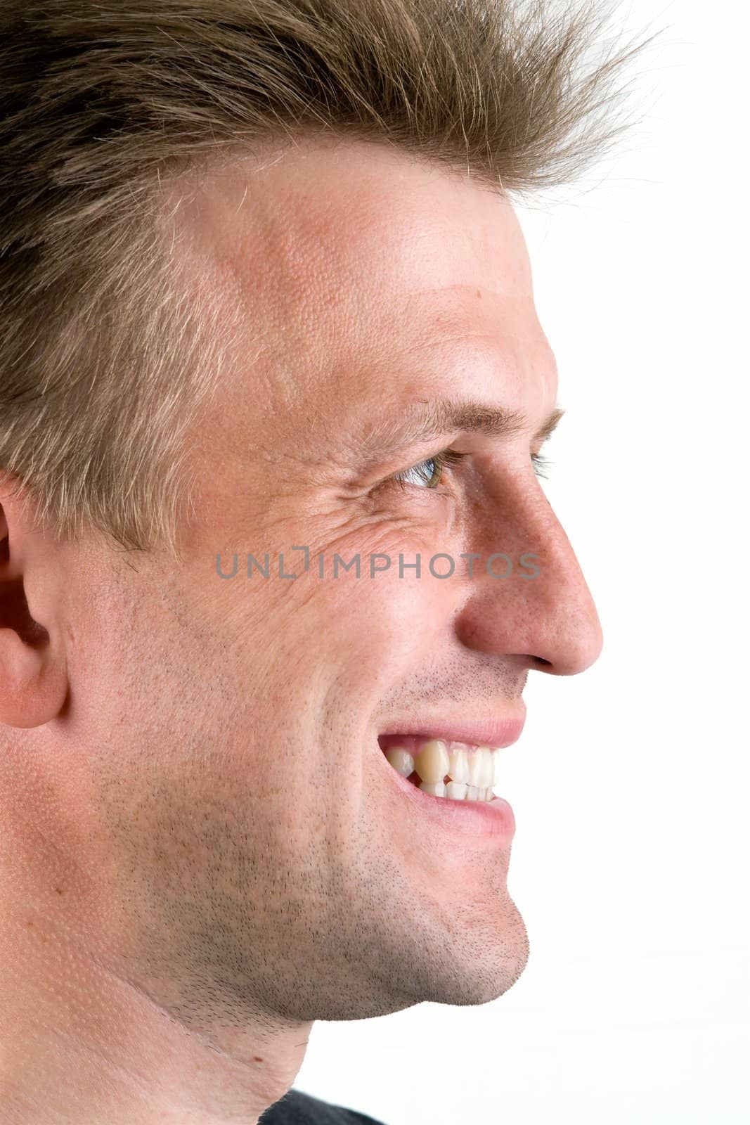 Profile. Portrait of the young smiling man. Face close up.