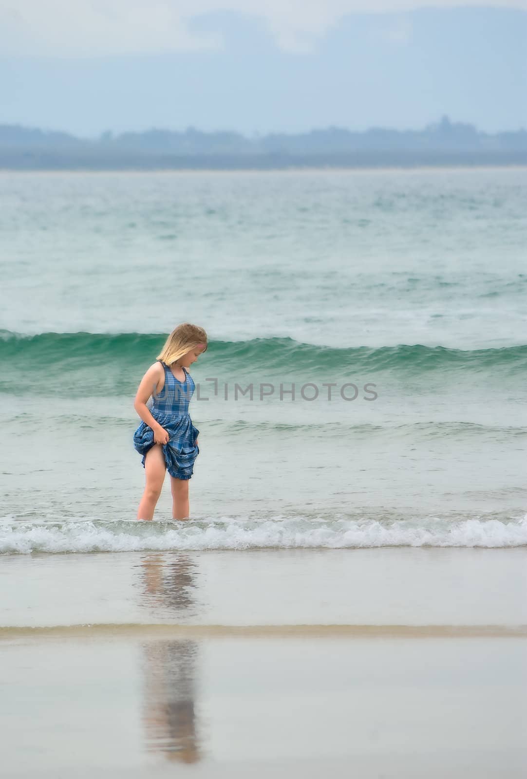 very soft dreamy image of a young girl at the beach