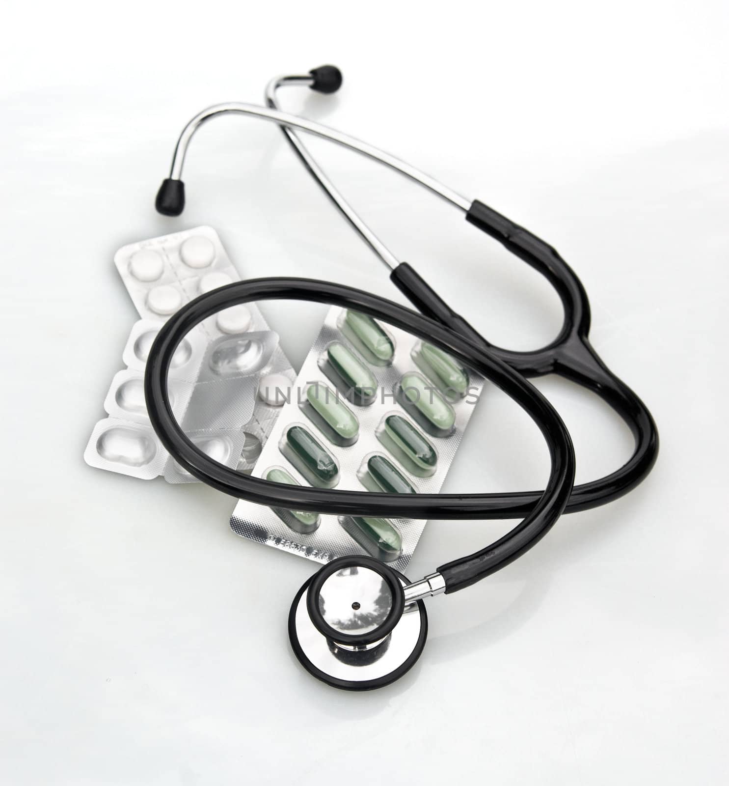 great image of a stethoscope and pills on white background