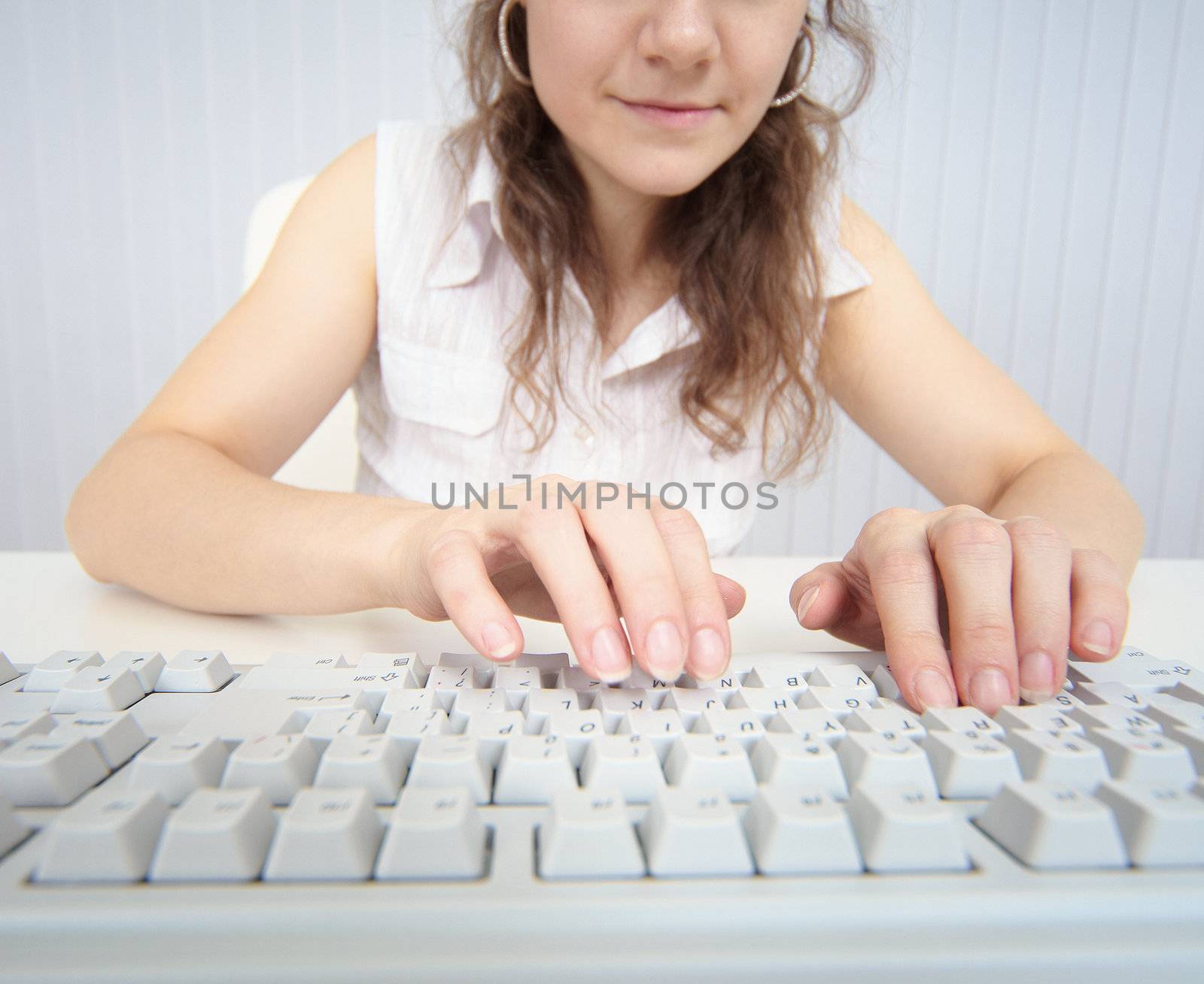 A woman working at a computer keyboard