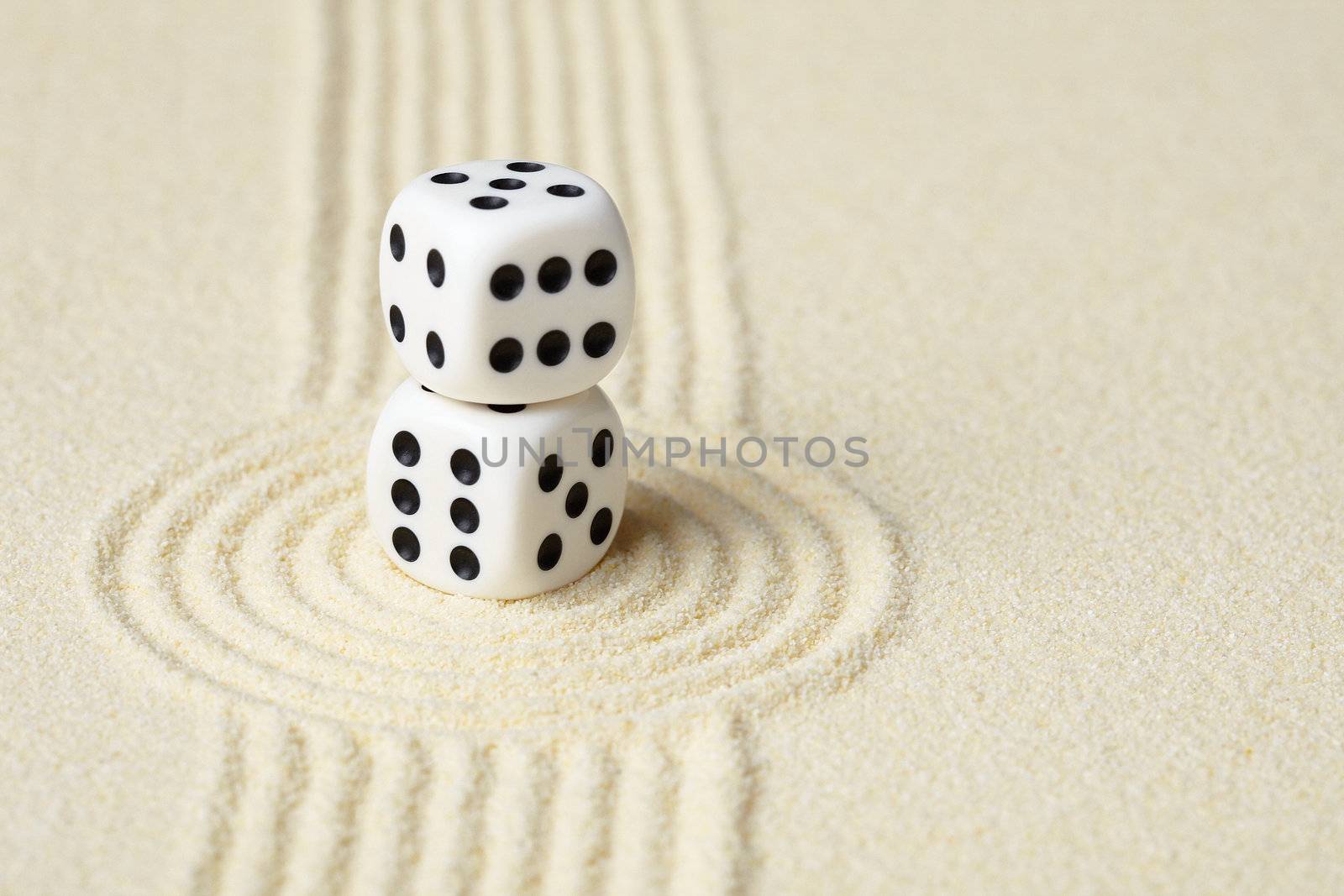 Composition on Zen garden - yellow sand, and two dice