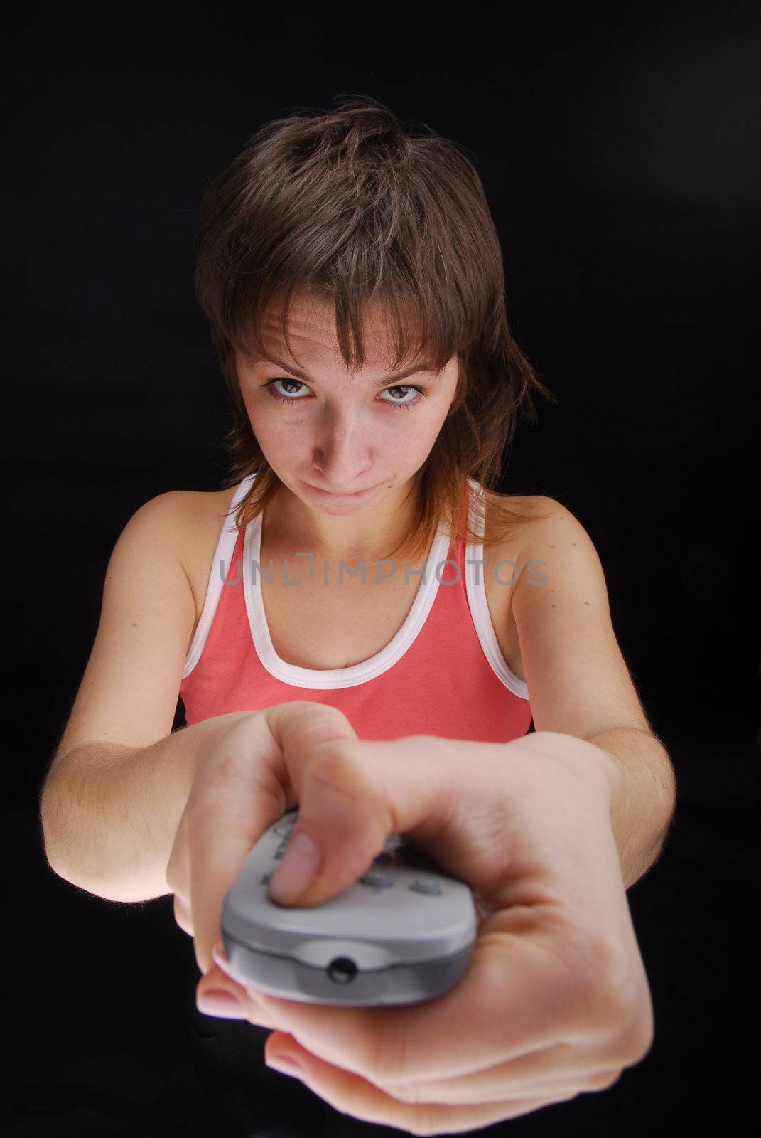 Young woman with tv remote control , isolated on black background