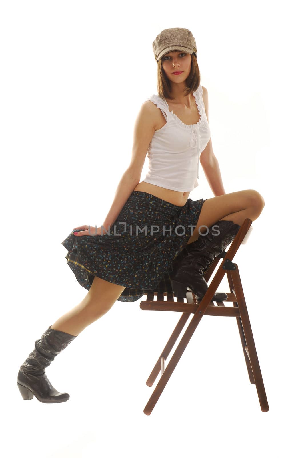 Young woman near the chair dresses in skirt