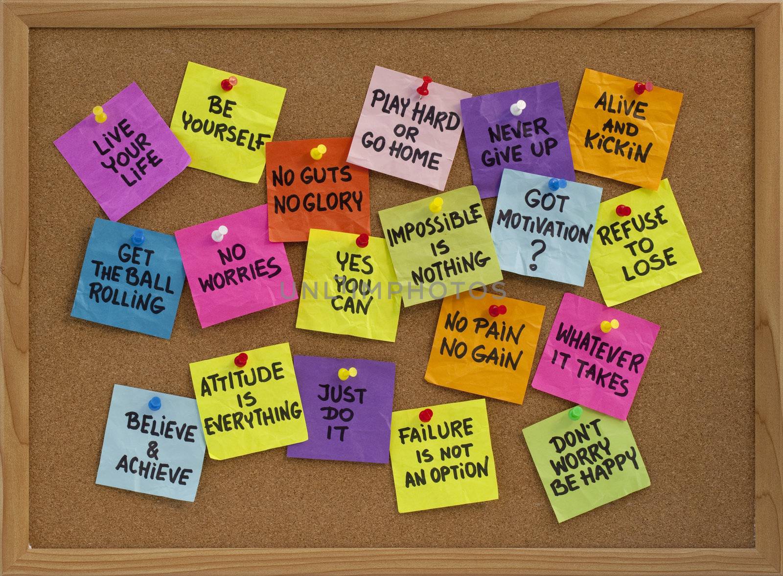 motivational slogans and phrases - colorful reminder notes with handwriting on cork bulletin board