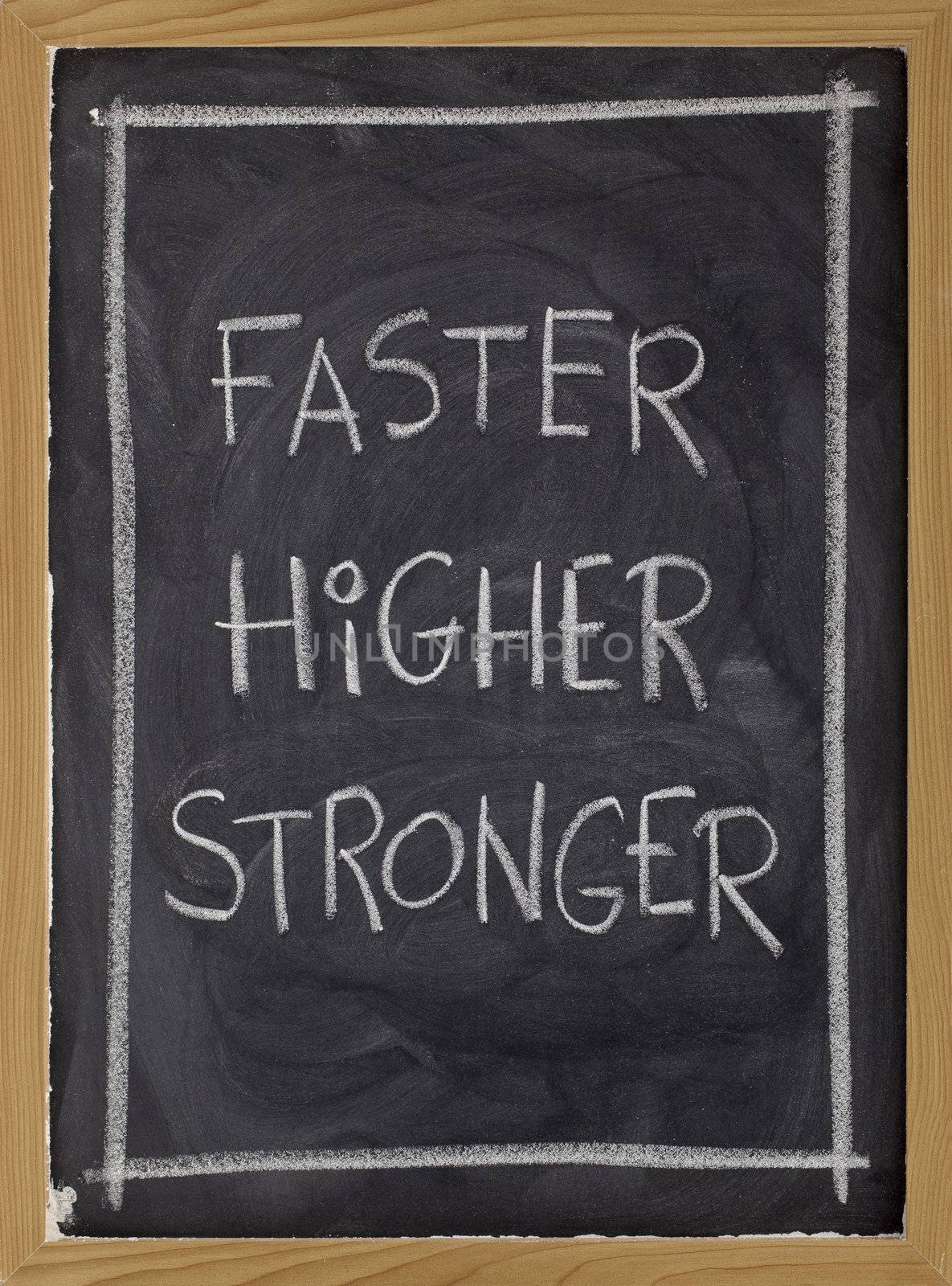 olympic motto (faster, higher, stronger) handwritten with white chalk on blackboard