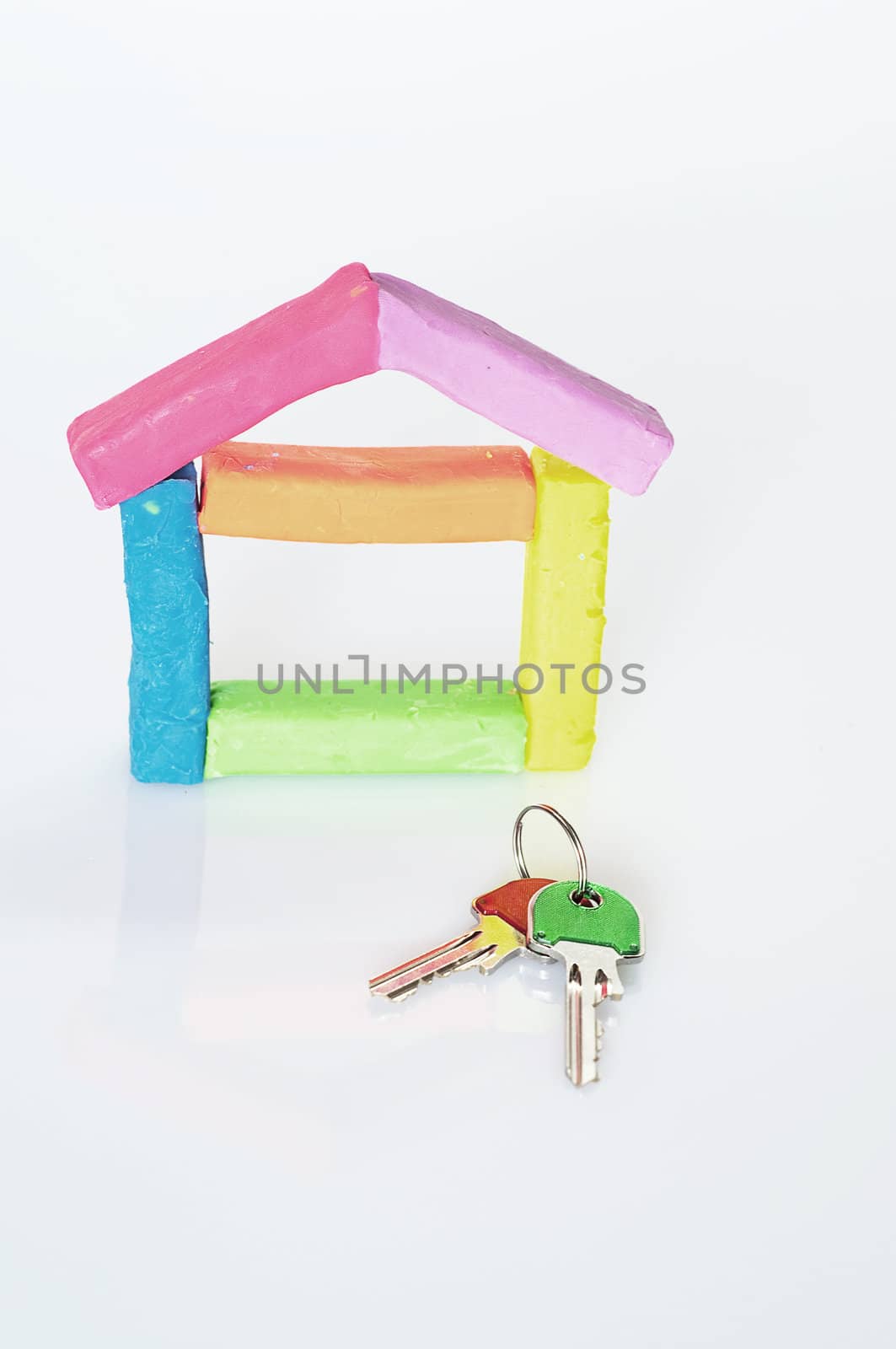 house composed of colored clay on a white background with two keys of different colors