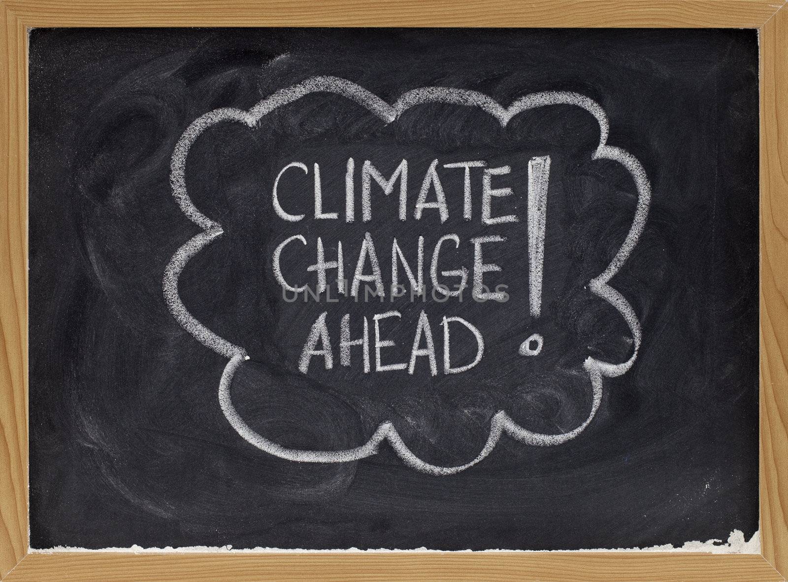 climate change ahead - white chalk handwriting on a school blackboard