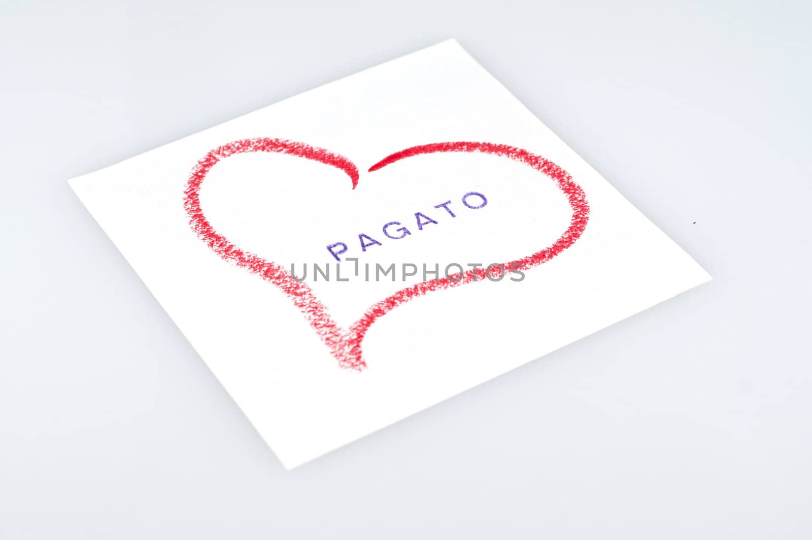sheet with heart drawn with lipstick and writing paid