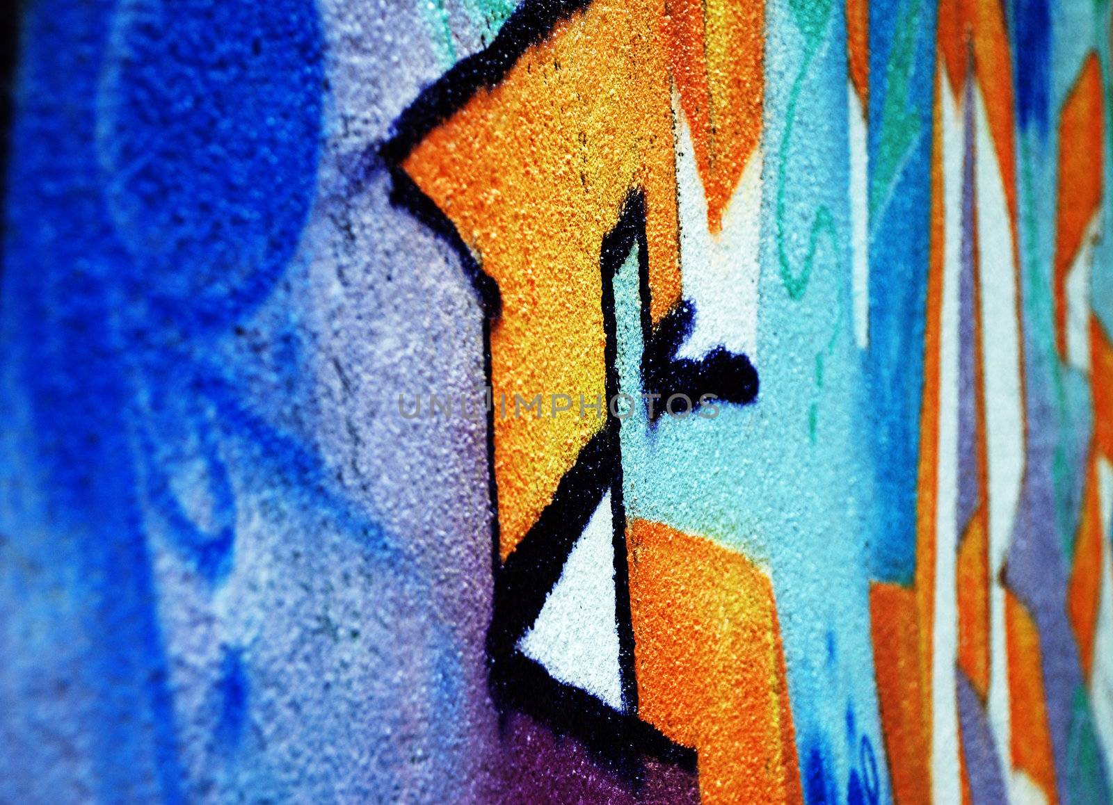 A wall covered in spray painted graffiti