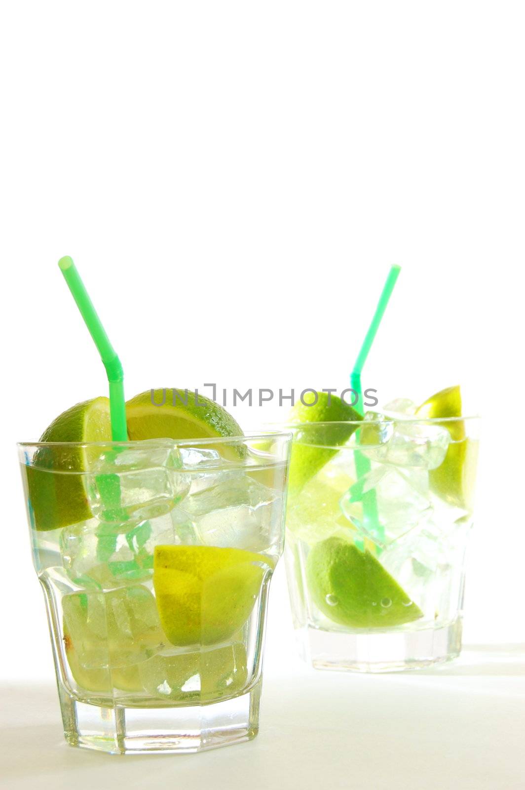 Caipirinha cocktail with lime on white background