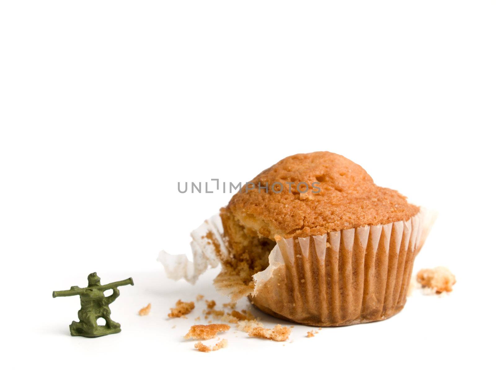 A toy soldier shooting his bazooka at a muffin. A conceptual image about the importance of a healthy lifestyle.