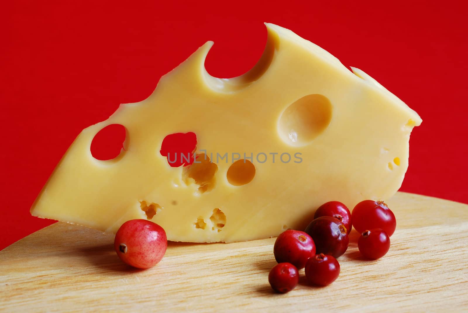 Piece of cheese on a red background