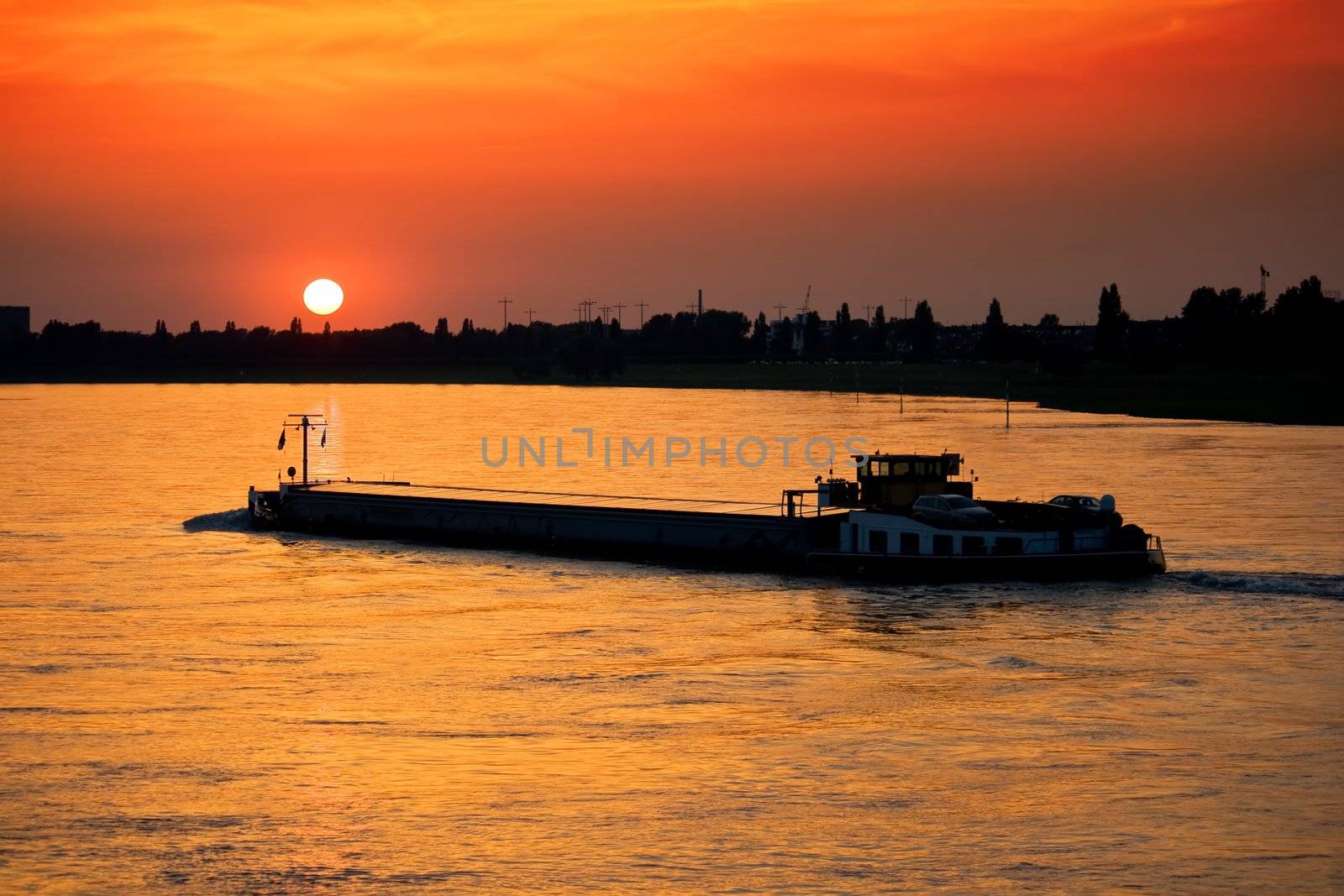 Barge with cargo at sunset