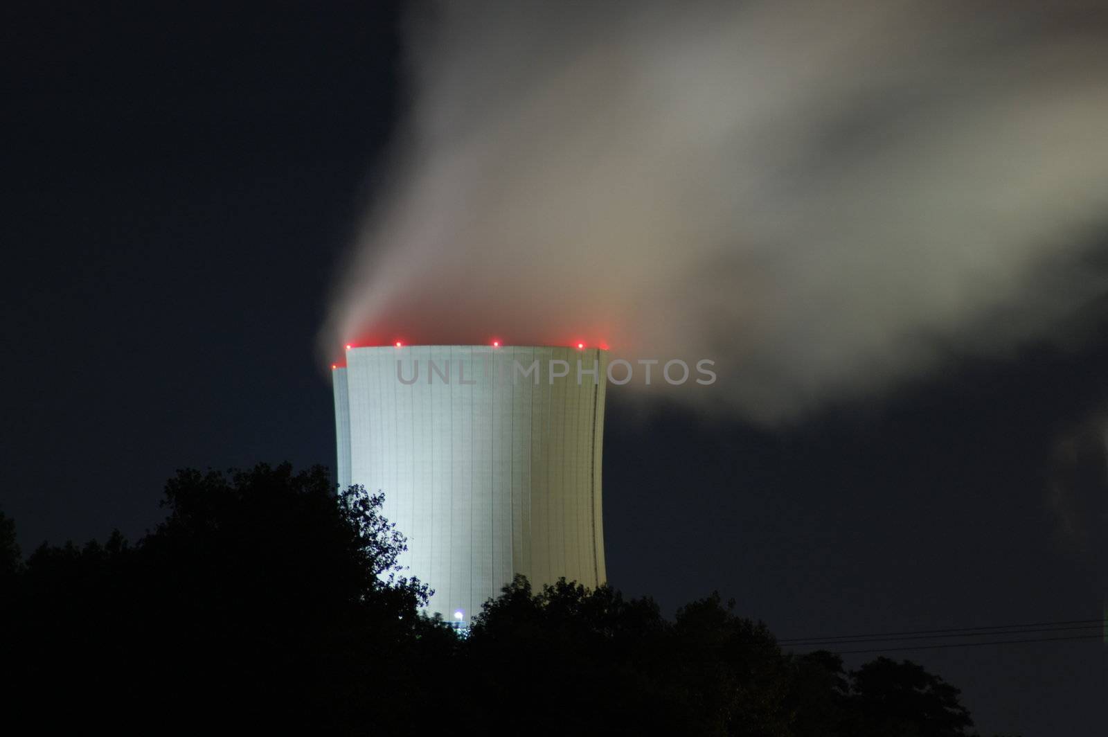 a smoking industrial power plant at night