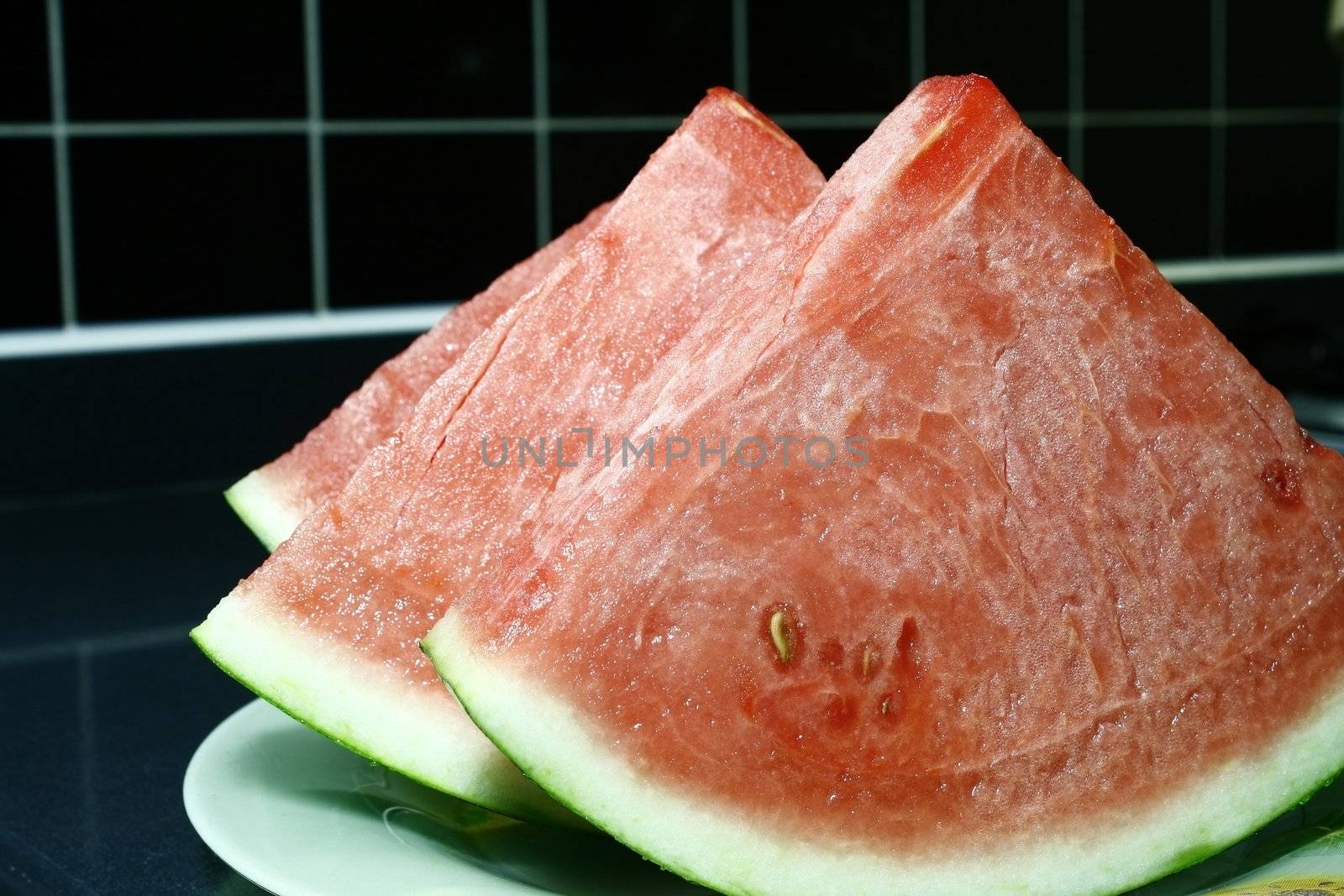 Fresh cut Watermelon in a black tile background