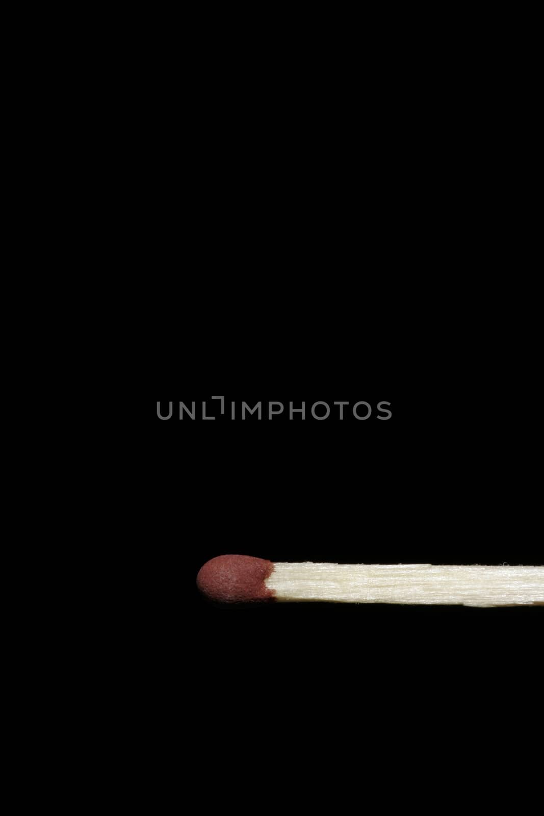 Single Wooden Matchstick With A Red Head On A Black Background