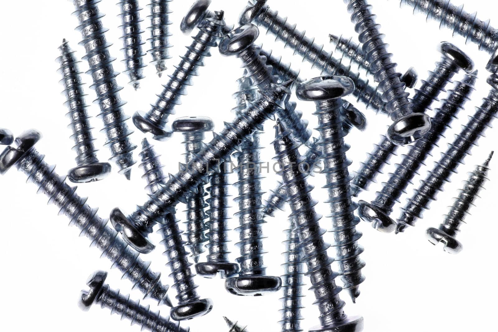 Macro Close-Up Of Spiral Metal Screws On A White Background