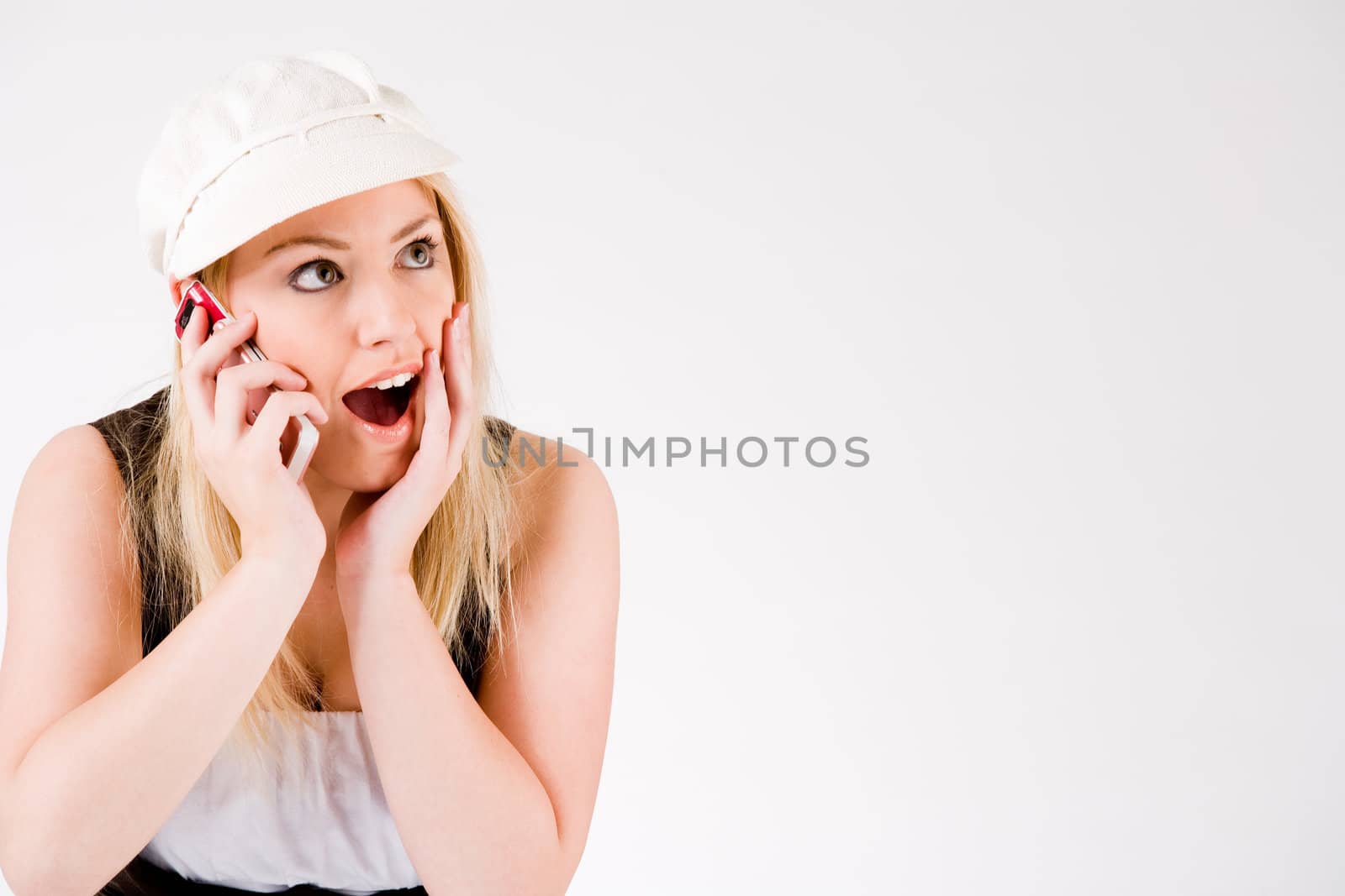 Young blond girl is busy with her cell phone