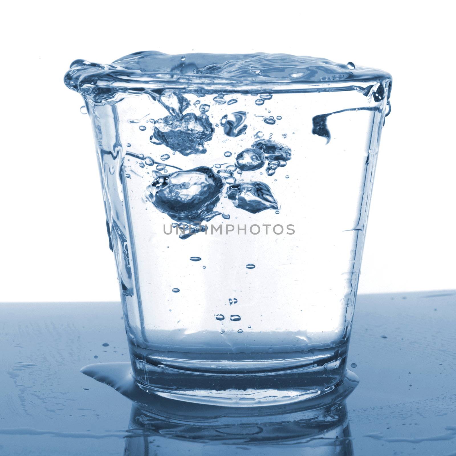 splashing water pouring in a glass with bubbles