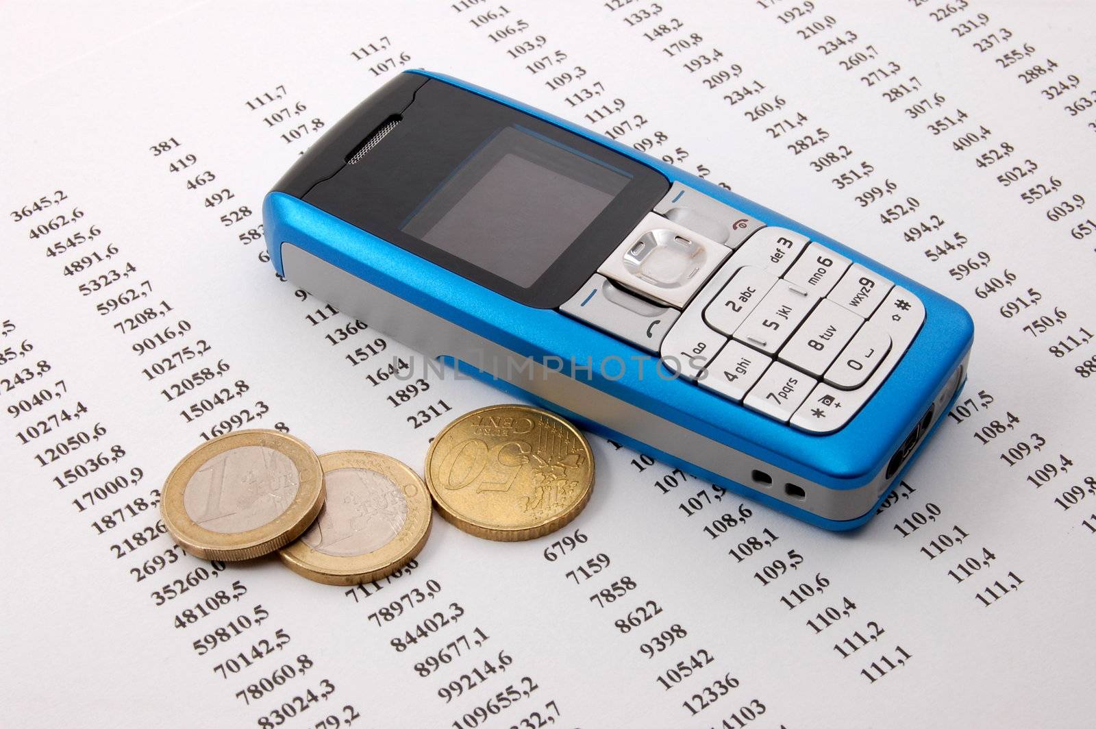 blue cell phone over business chart showing success