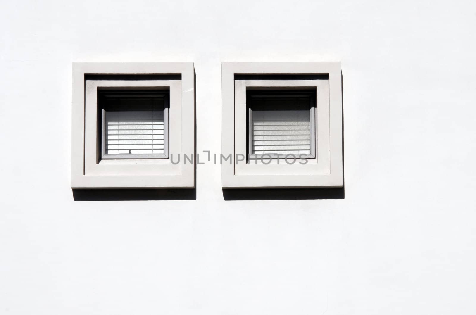 Two square window on a grey wall