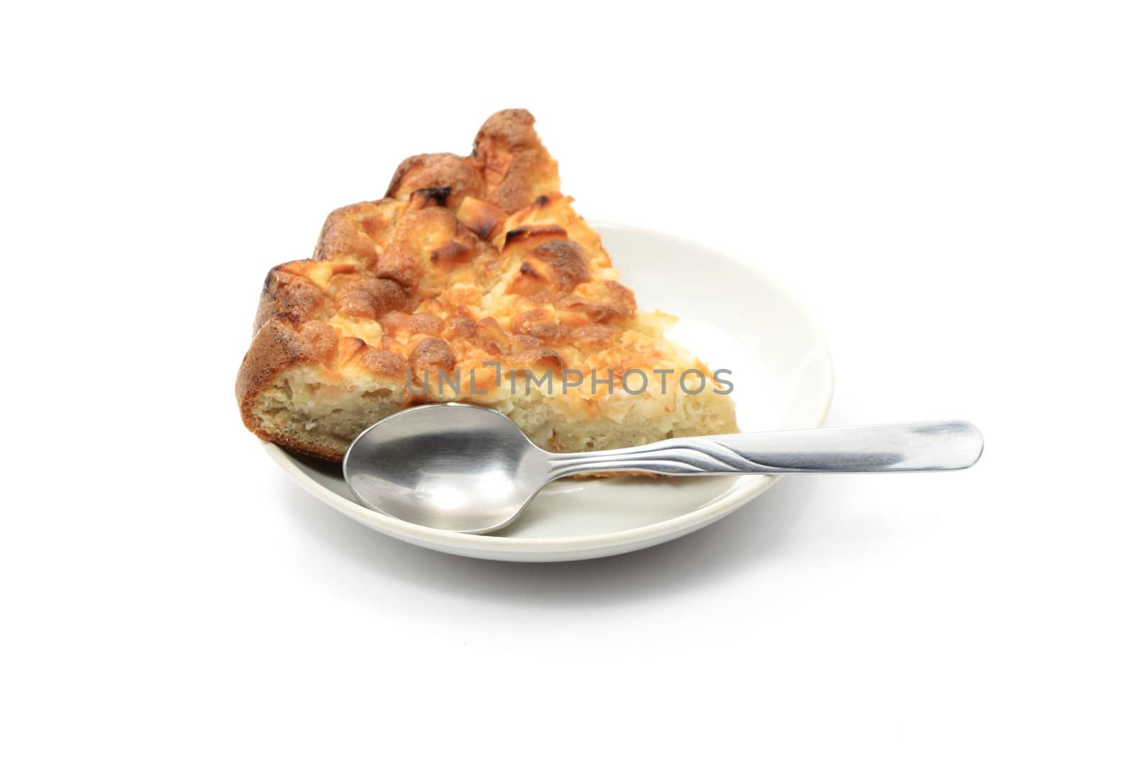 Piece of pie and spoon lying on soucer isolated on white background