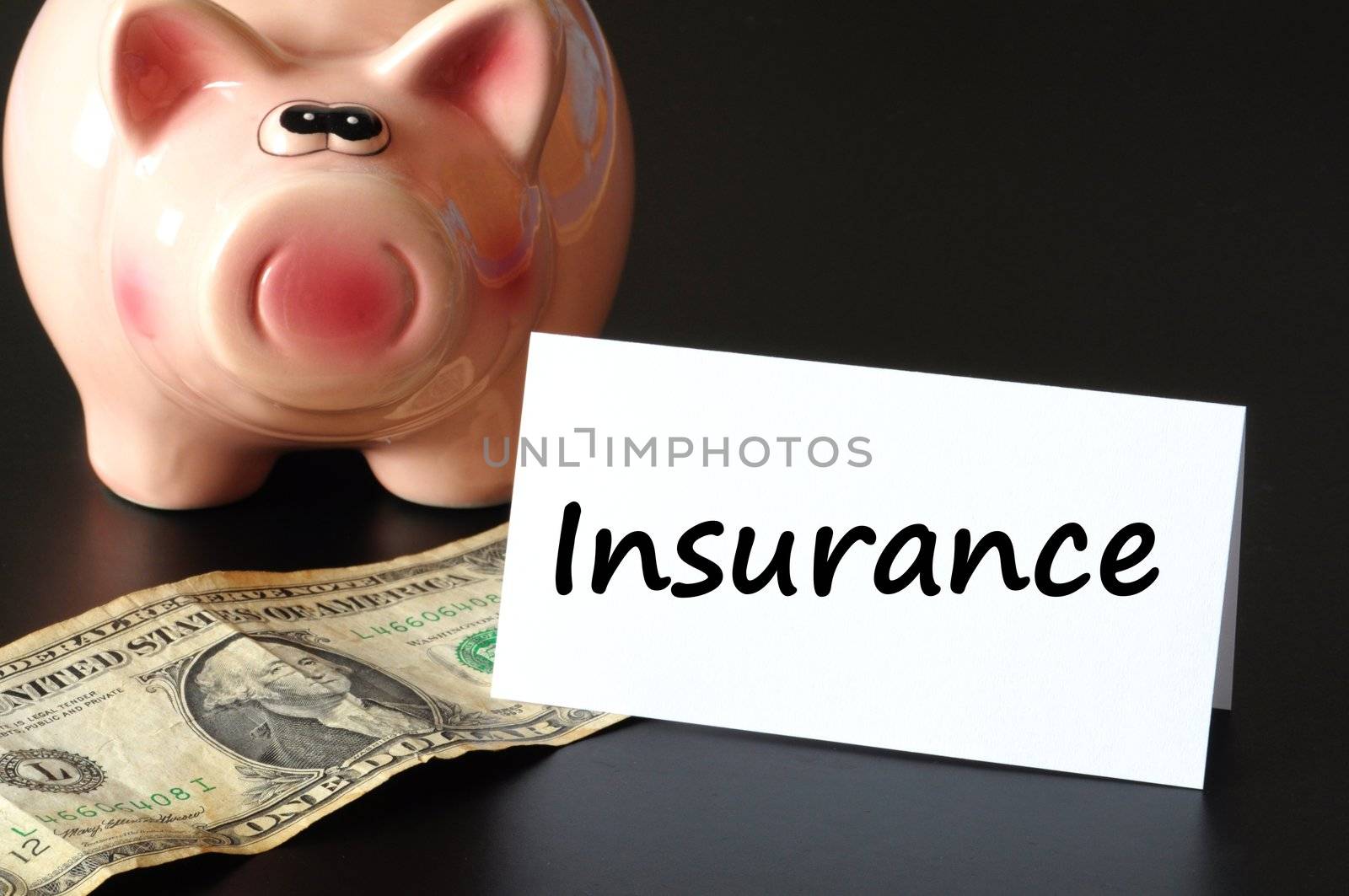 insurance concept with piggy bank and money on black background