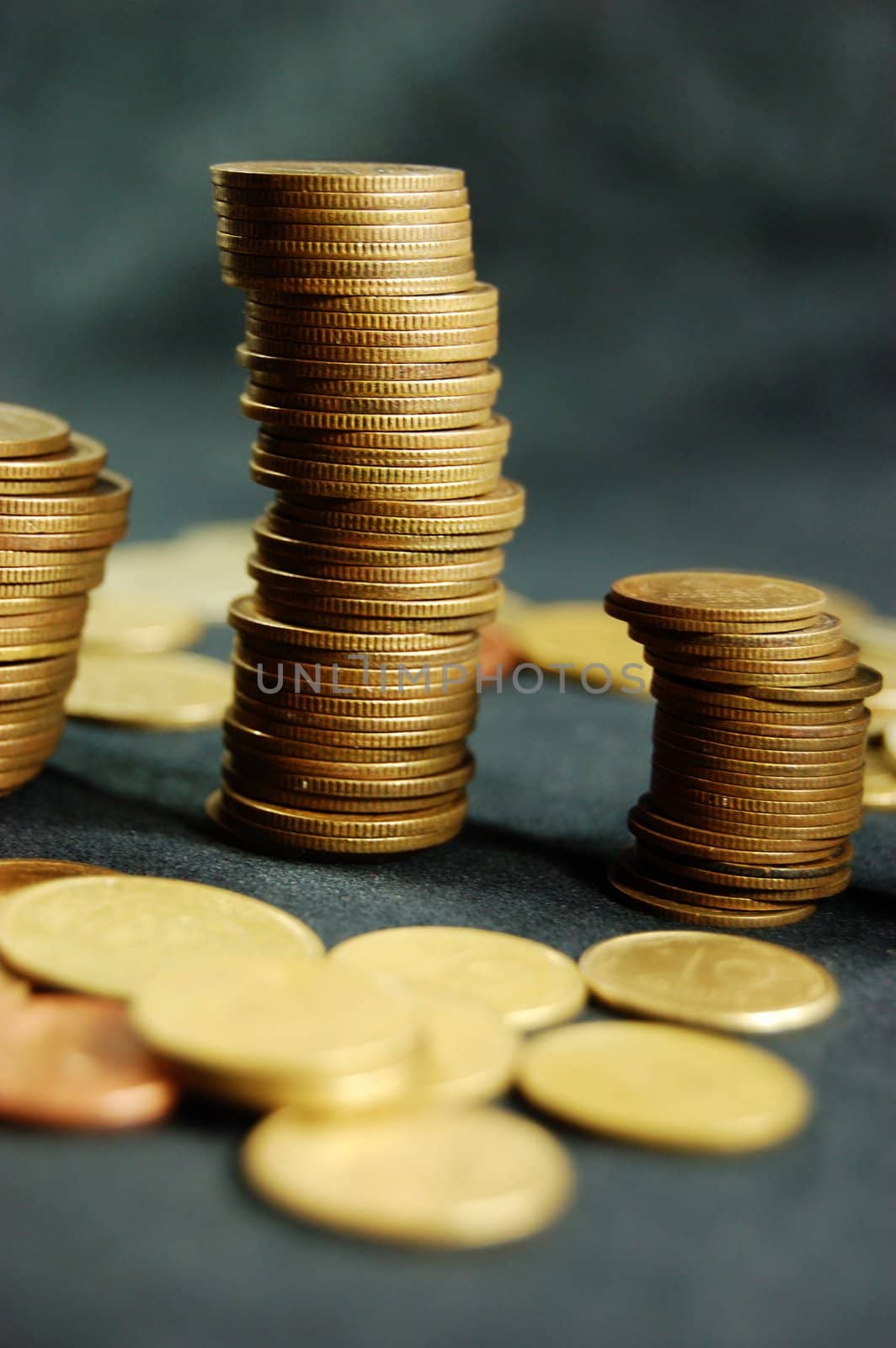 A pile of golden coins on dark background