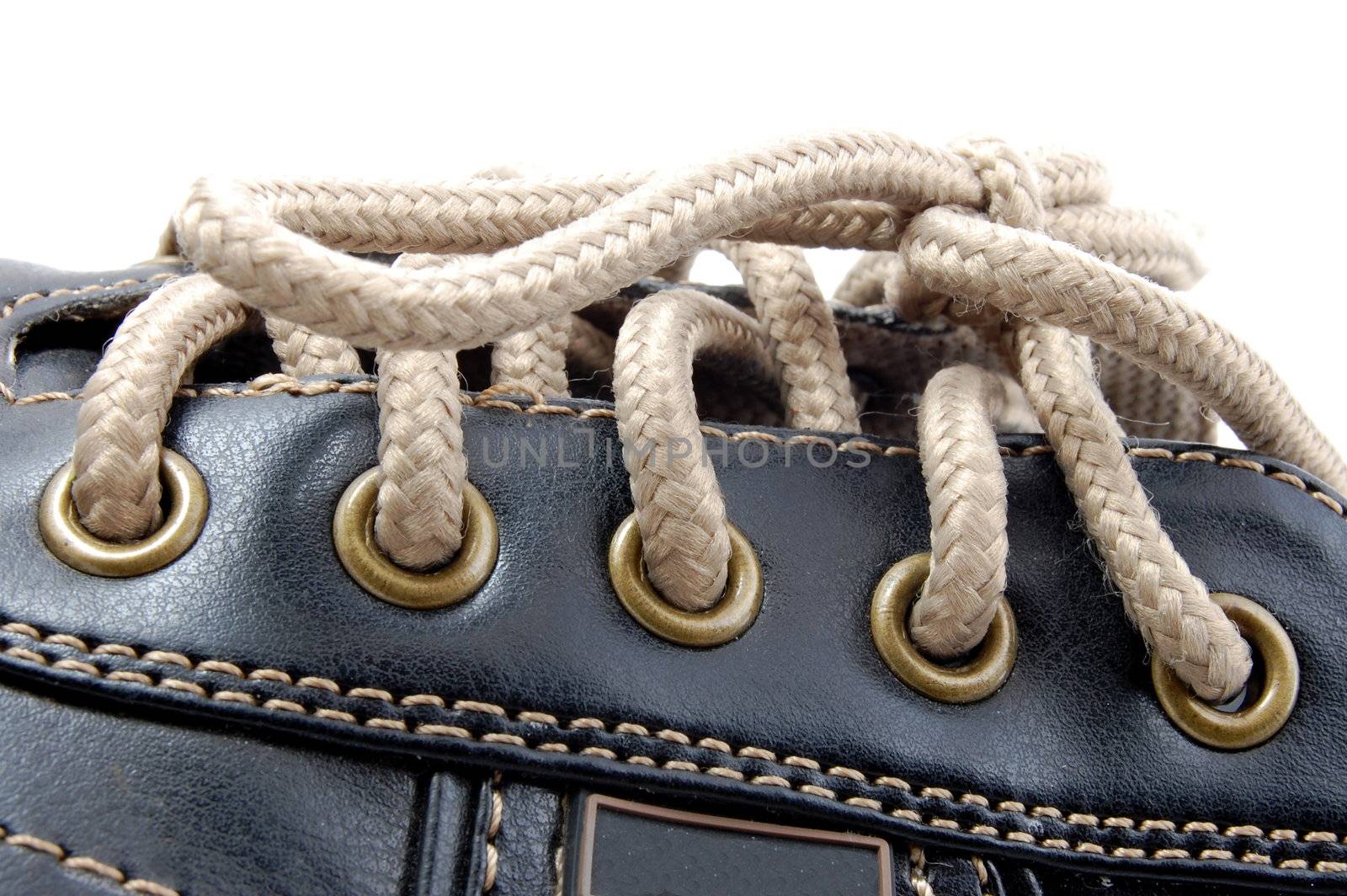 macro of a brown leather shoe and bootlace