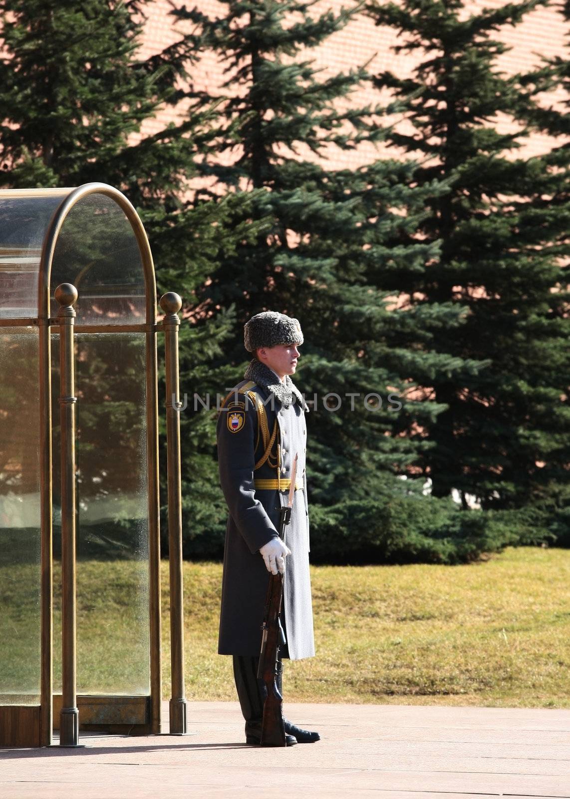 Russian soldier with the weapon, standing at attention