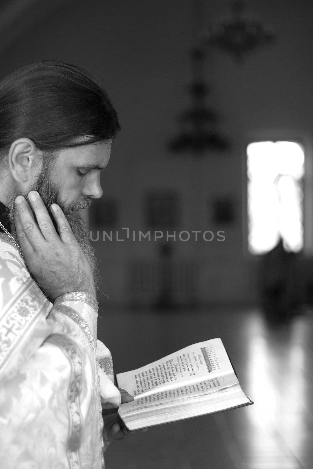 The priest with the Bible on ceremony of wedding of a newly-married couple. Moscow, the Patriarchal farmstead