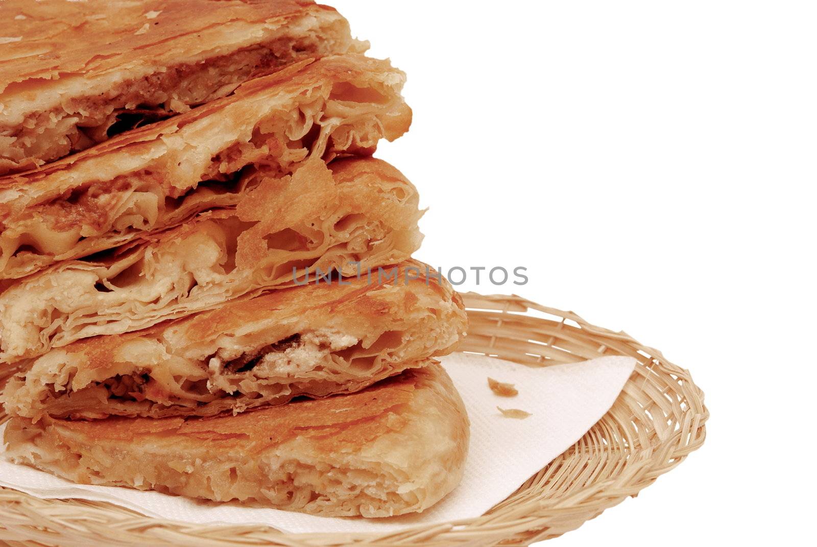 round burek slices in the basket close-up isolated over white background