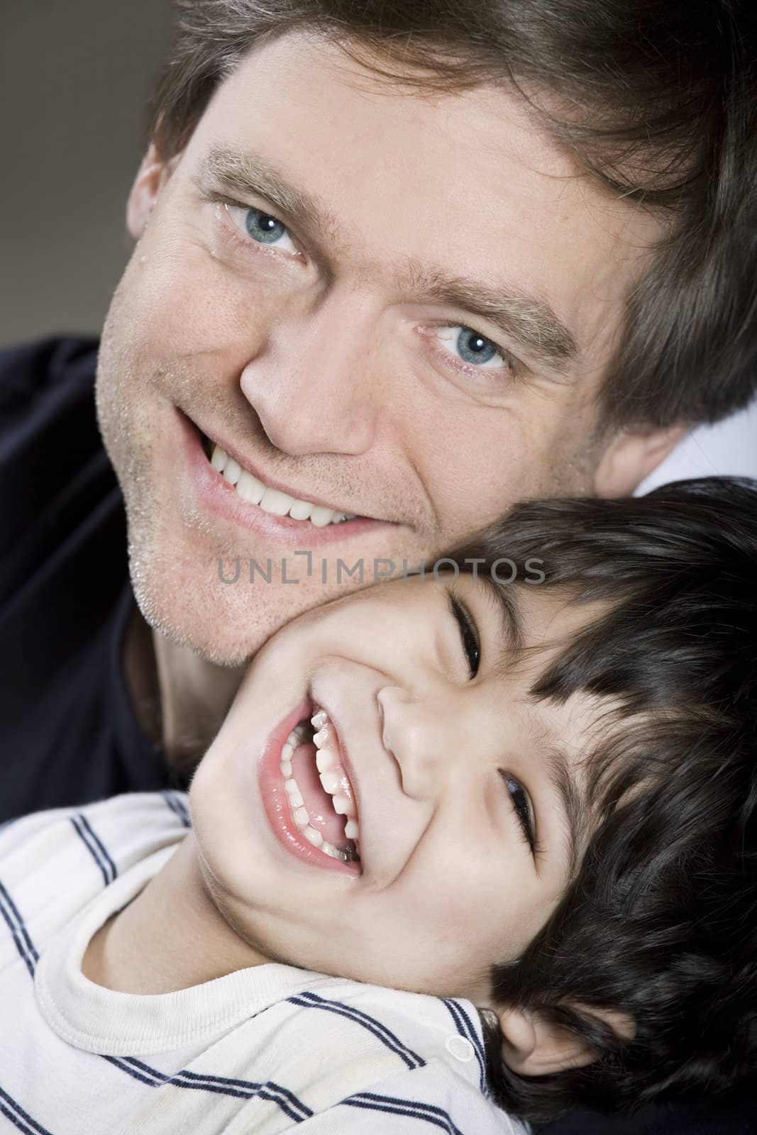 Father with his sonFather holding his son, smiling together