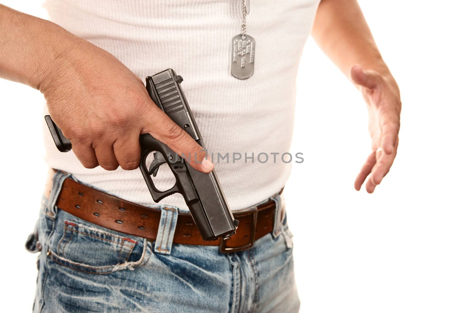 Closeup of man in t-shirt drawing gun from waist