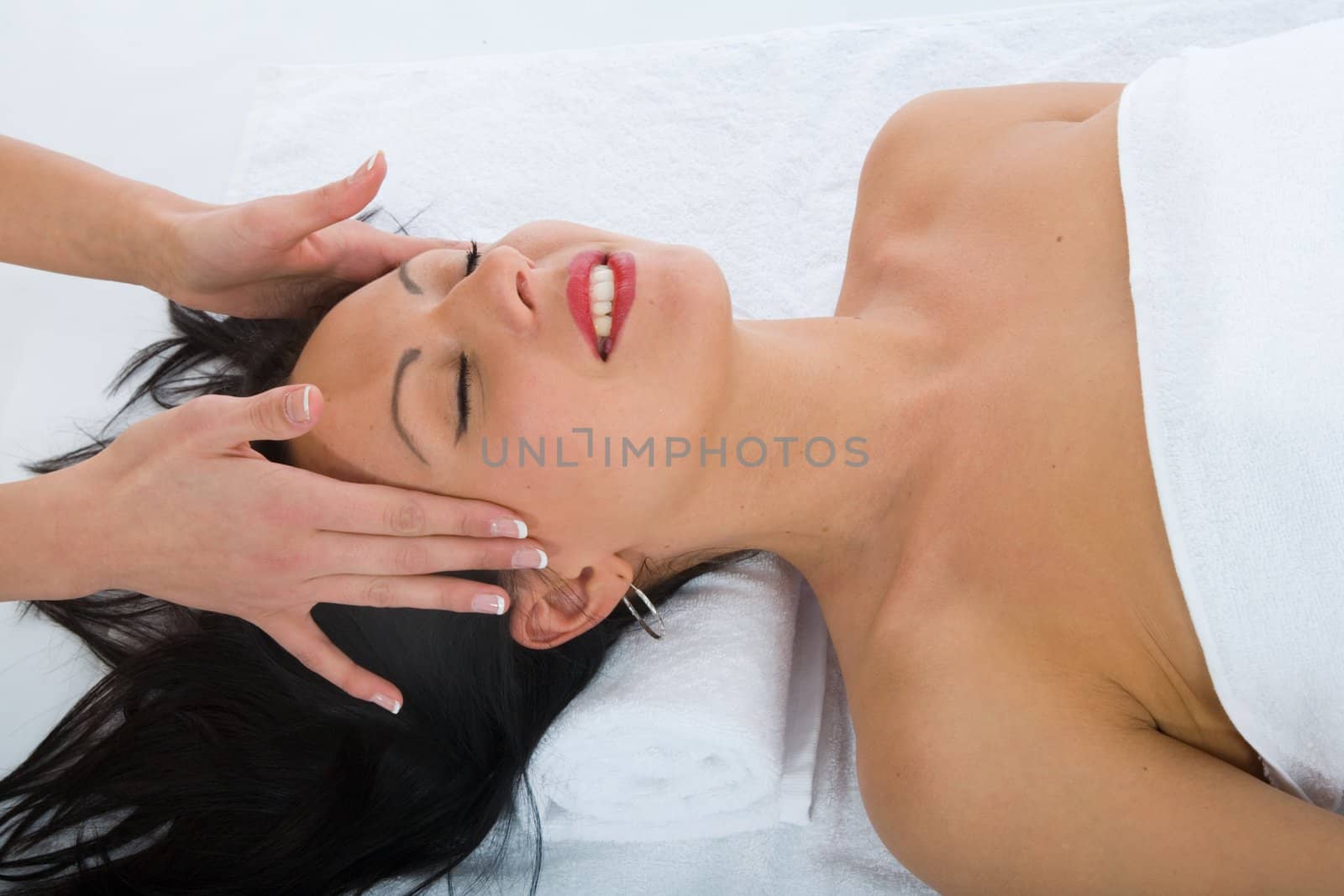 masseuse does relax facial massage to the girl