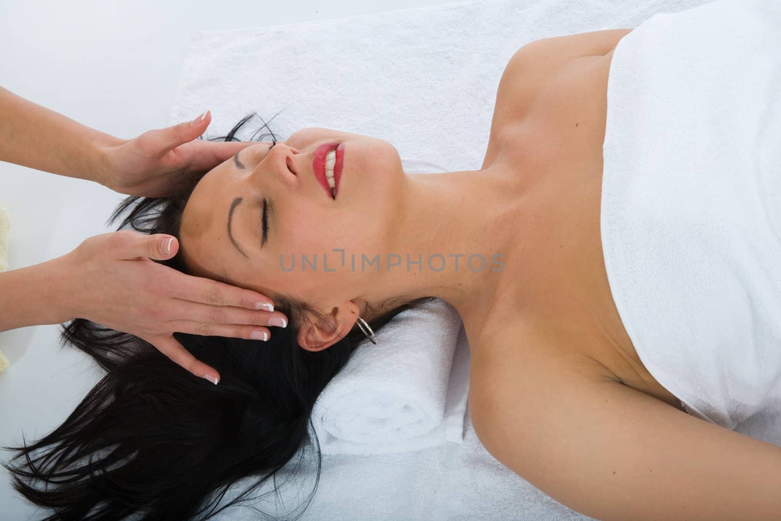masseuse does relax facial massage to the girl
