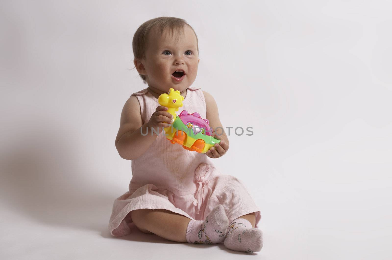 astonishment of  baby, funny little girl with toy