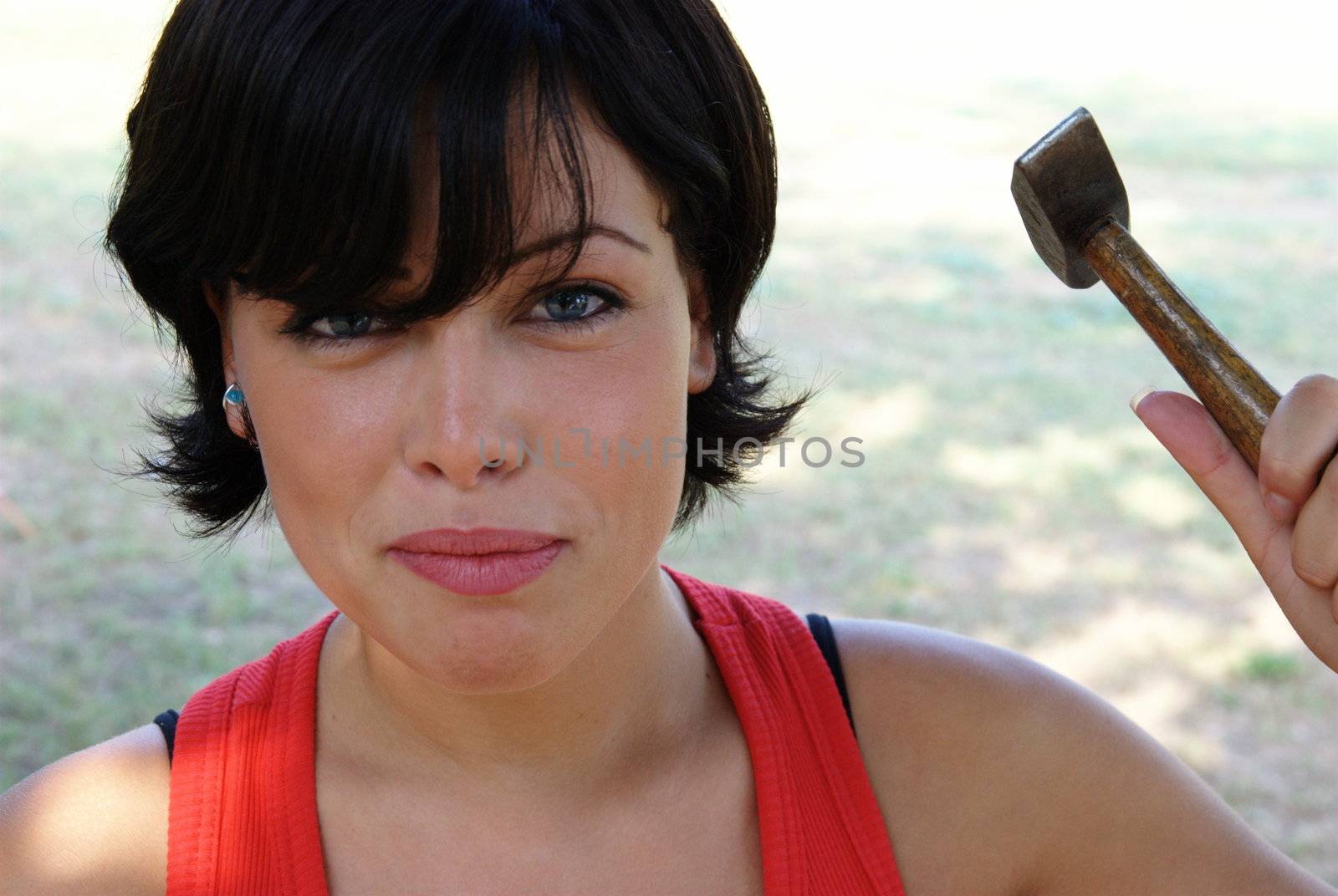 Angry lady ready to hit with a hammer