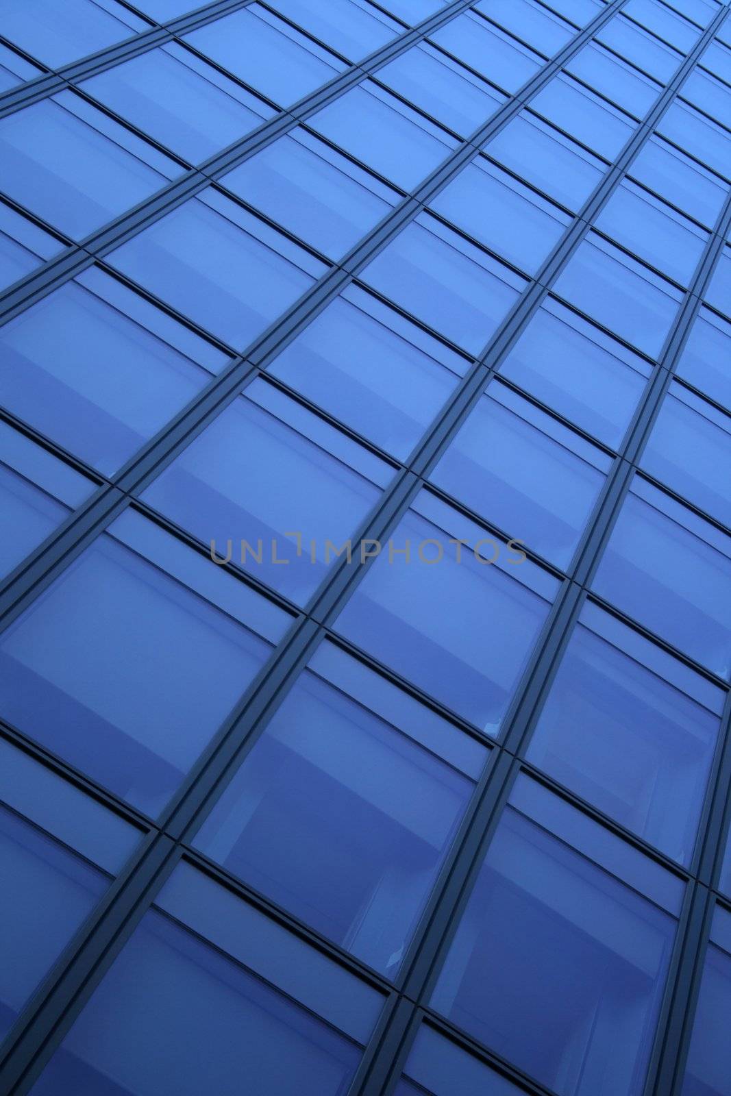 Blue windows of a skyscraper, forming a diagonal pattern.