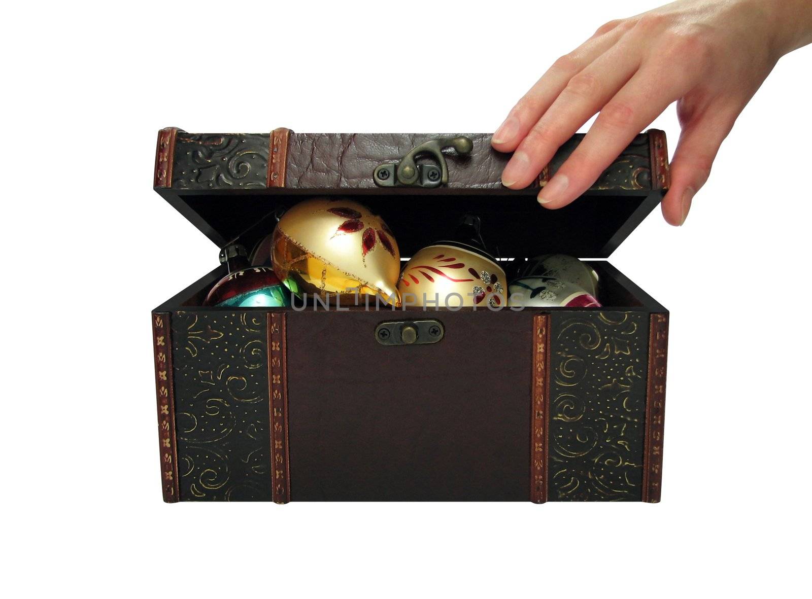 Hand of a woman opening a treasure chest filled with Christmas balls. With clipping path.