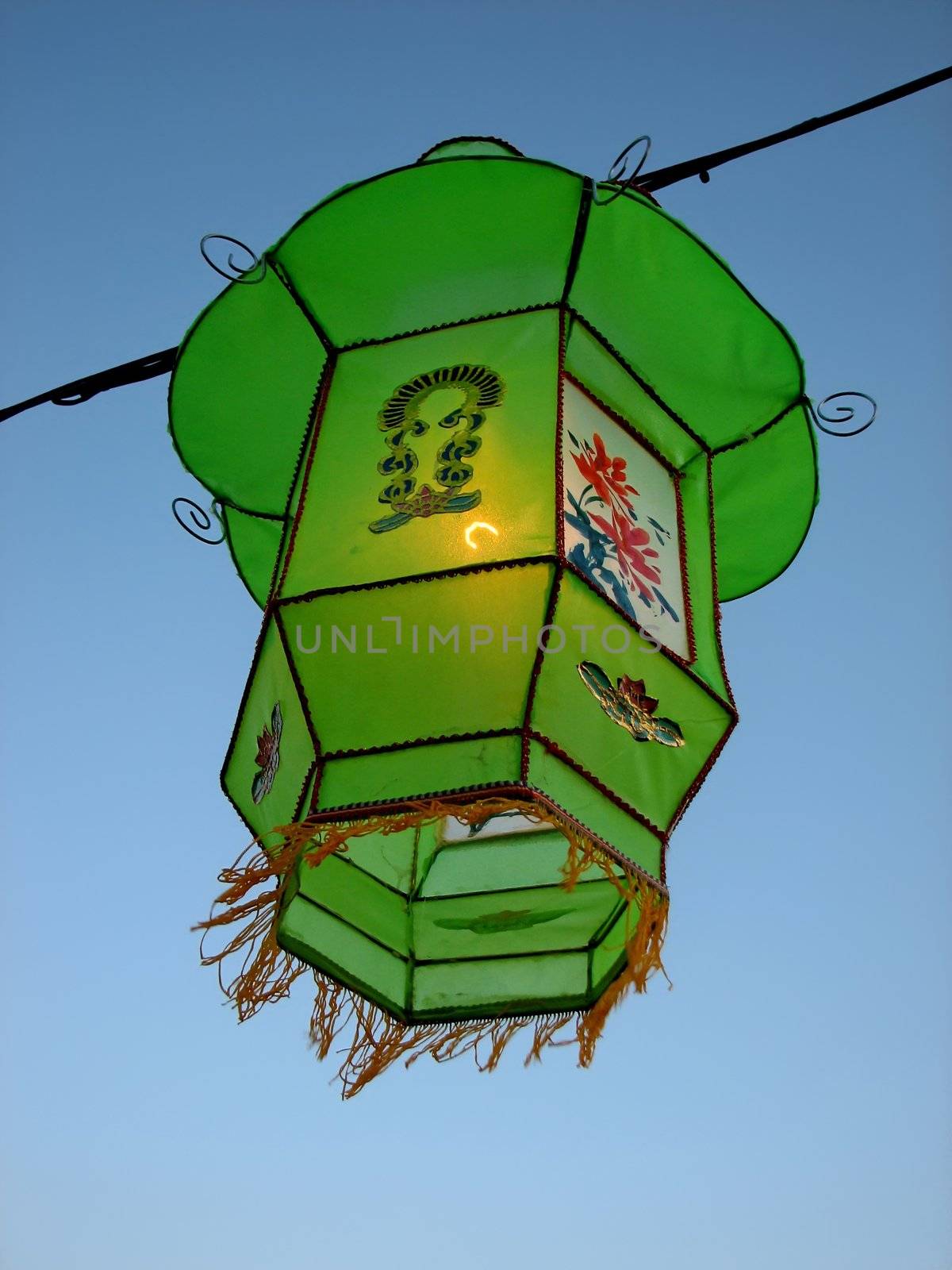 Cozy light of a green Chinese lantern by anikasalsera
