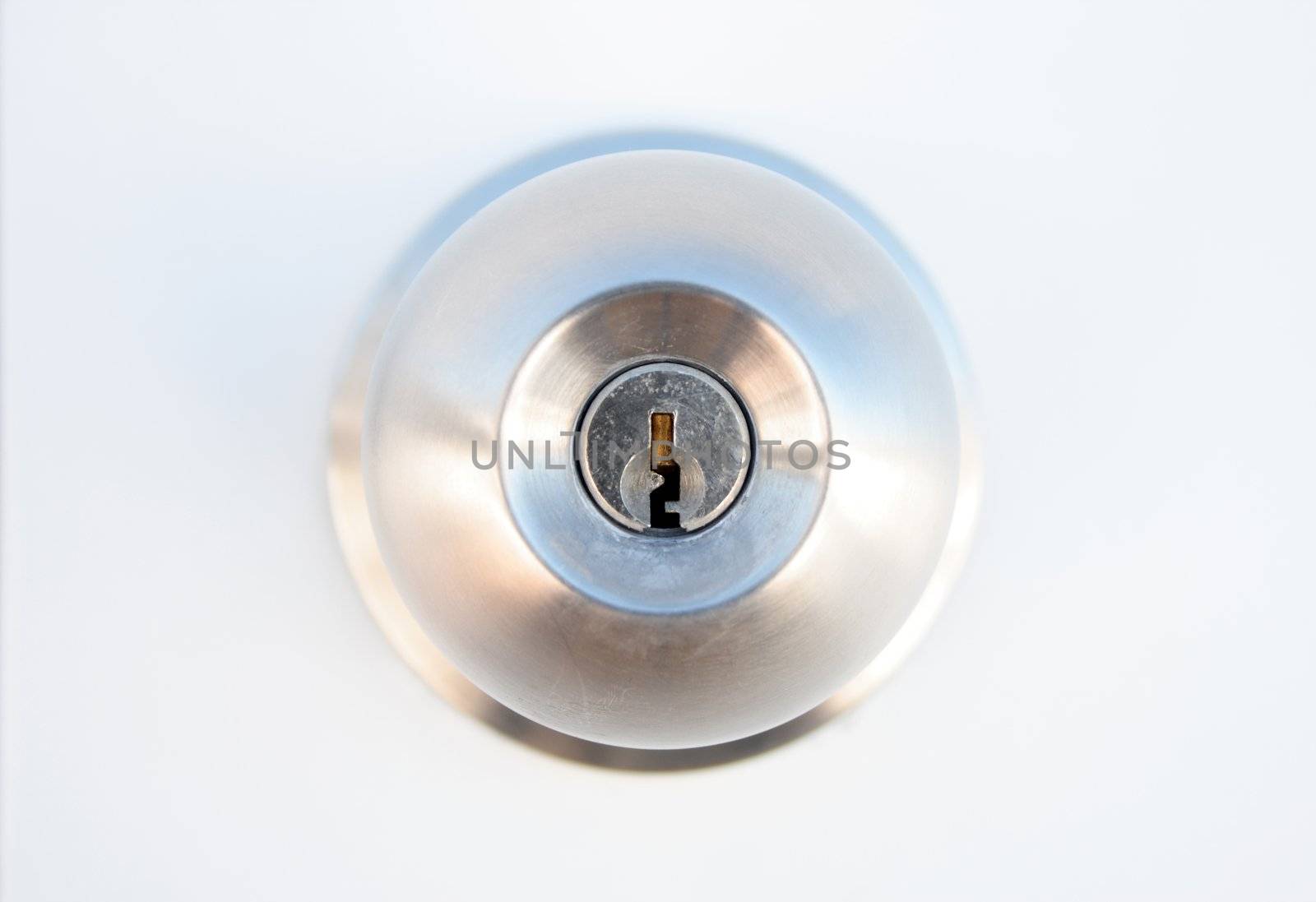 Closeup of metallic door lock with focus on keyhole.